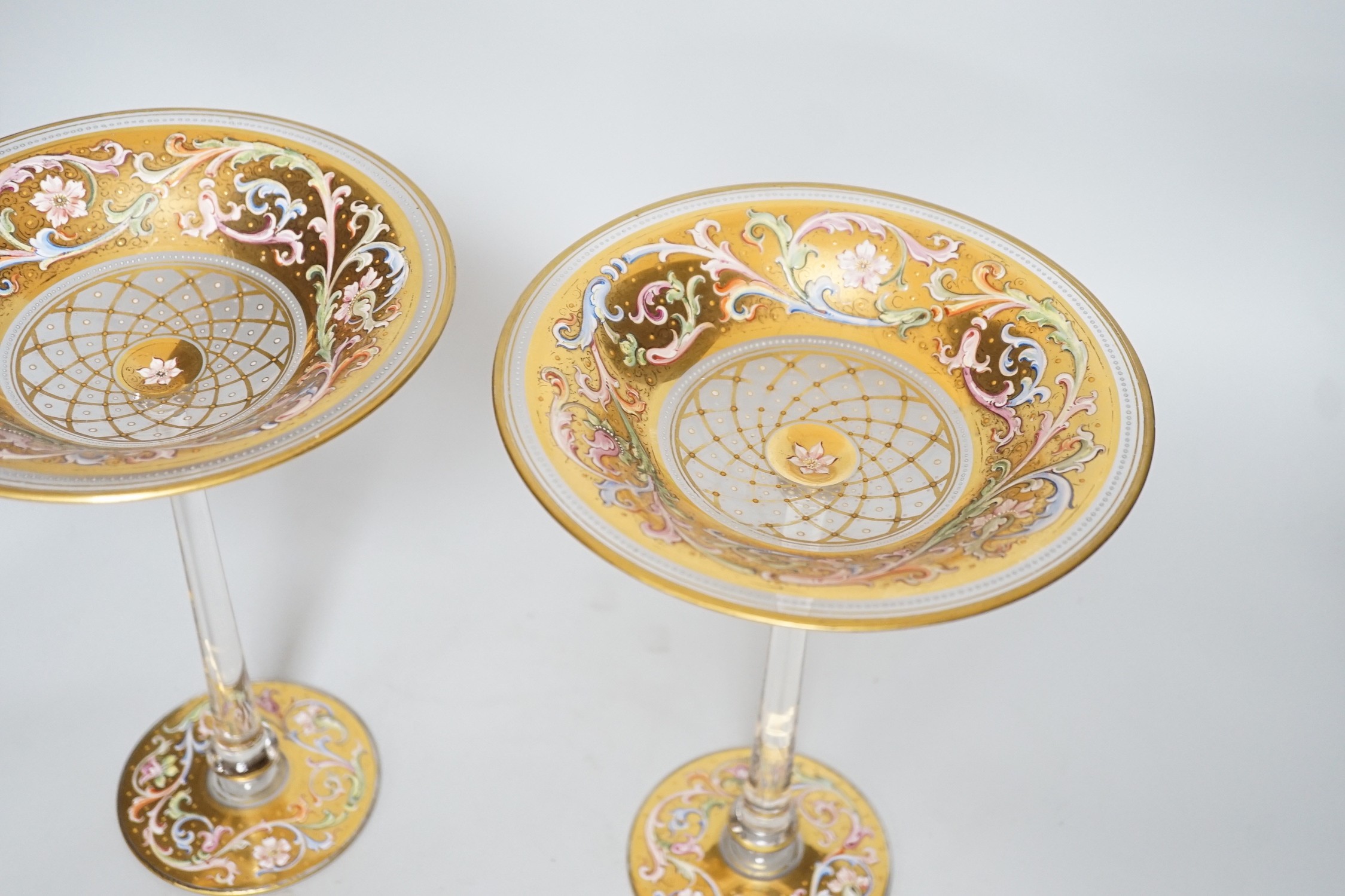 A fine pair of Bohemian enamelled glass tall pedestal bonbon dishes, probably Moser, late 19th century, 25.5 cm high, dish tops 18.5 cm diameter